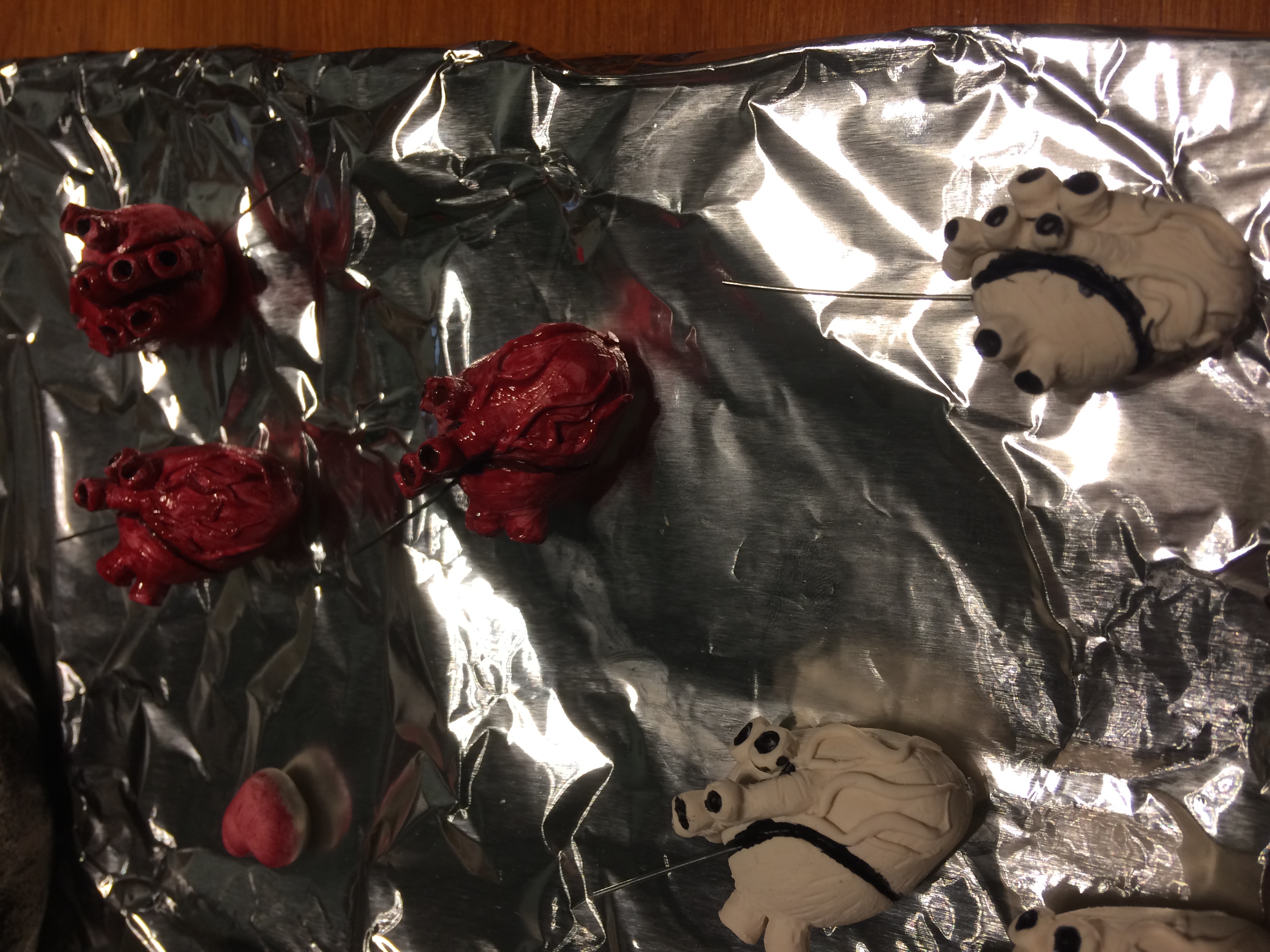 Painted human heart pendants